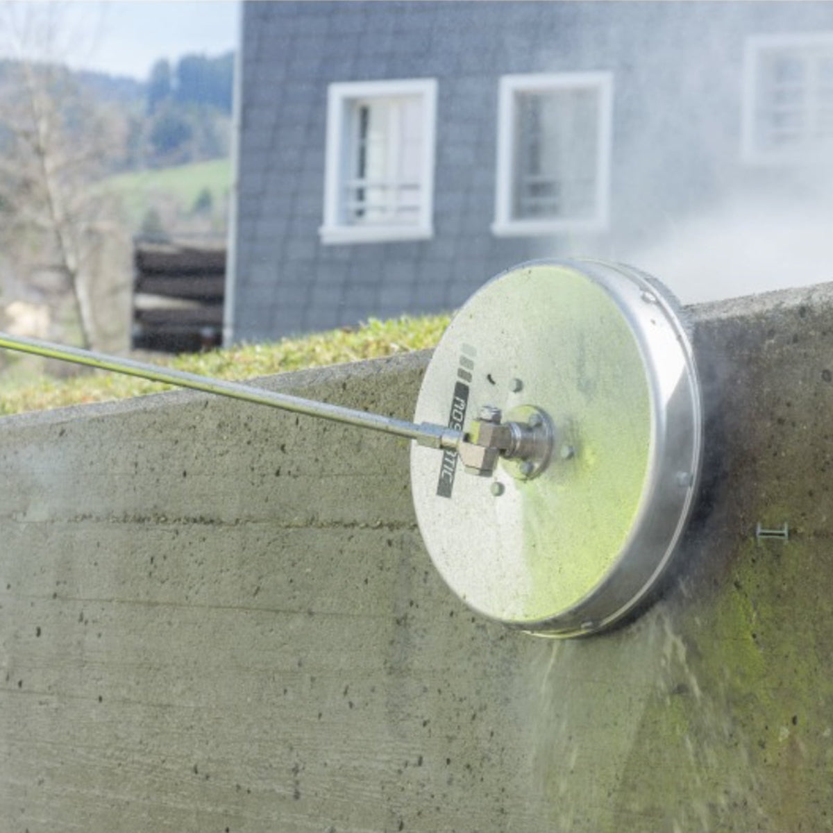 The 12" Mosmatic Flat Surface Cleaner can be paired with a pressure washer to clean concrete walls.