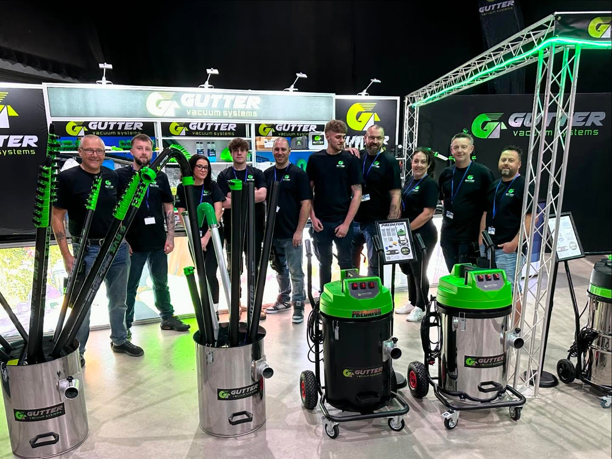 GVS team with gutter vacuum systems and carbon fibre poles at a trade exhibition
