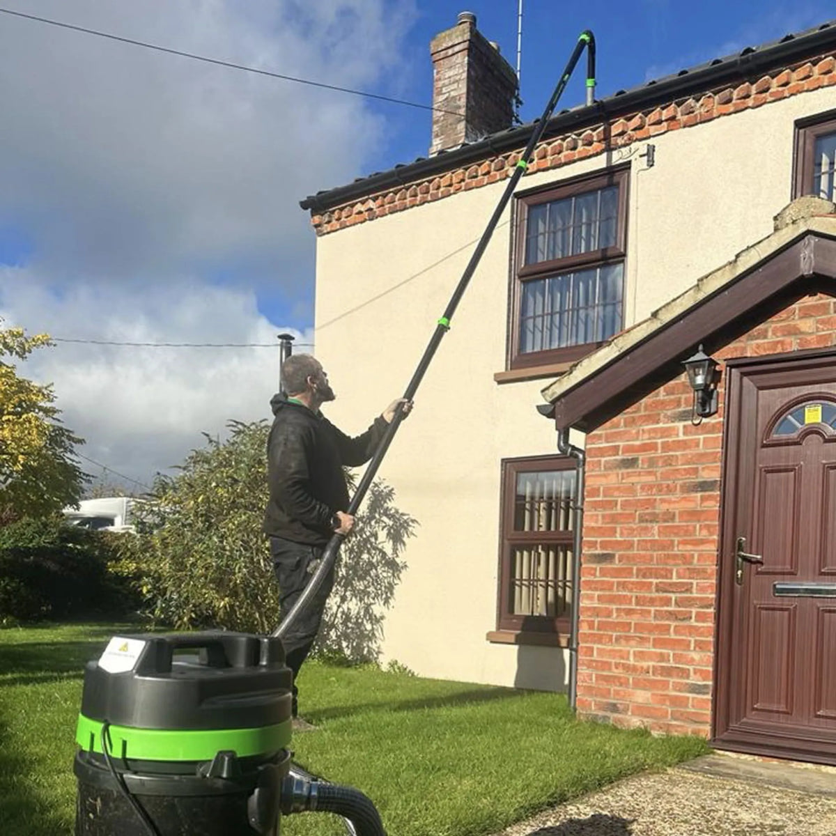 51mm clamped carbon poles in use with the 51mm carbon rigid neck connected to the Panther Gutter Vacuum.