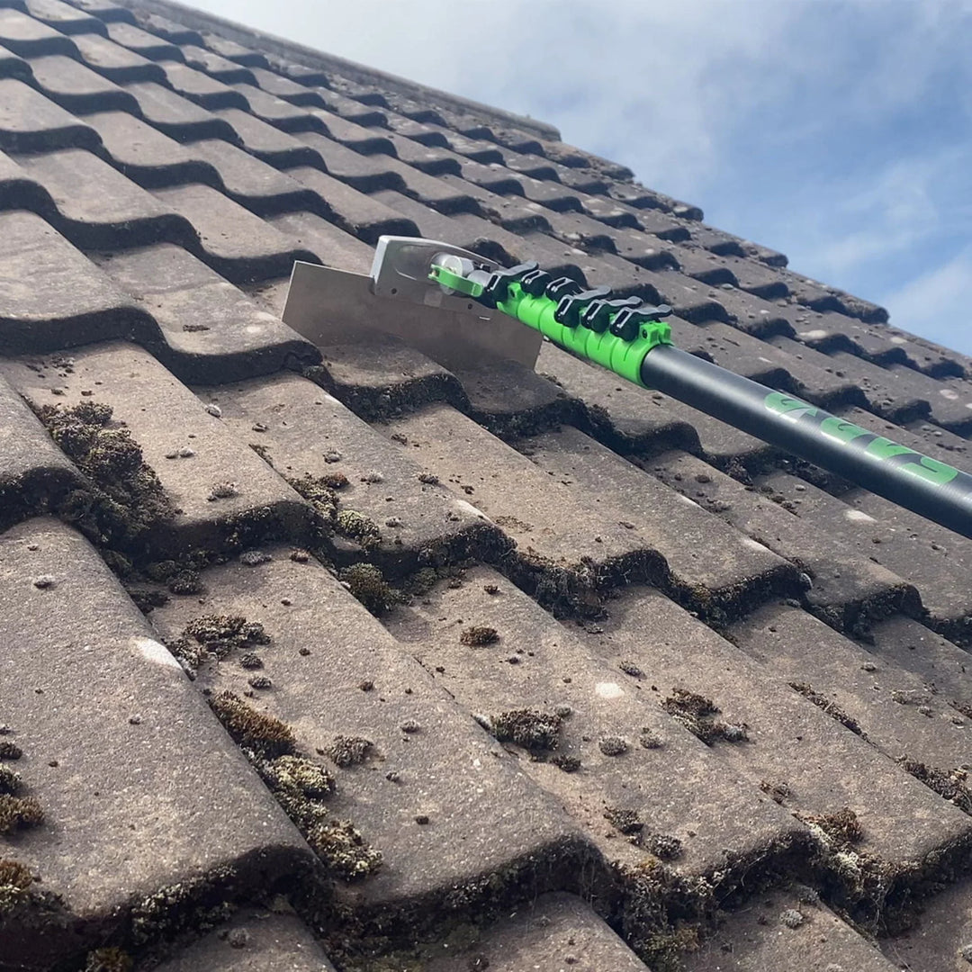 Ground-based roof cleaning equipment in use