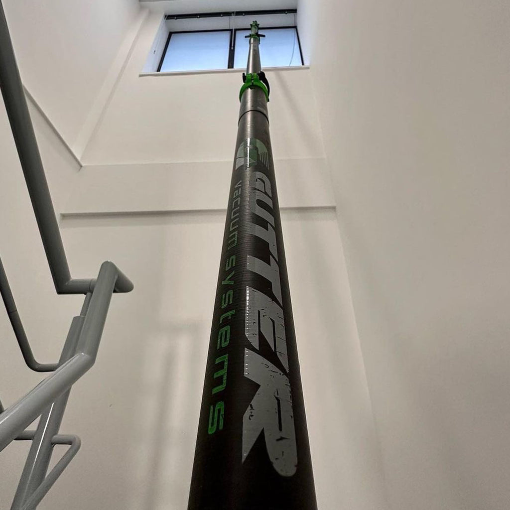 Gutter vacuum poles clear water from high level internal glass windows